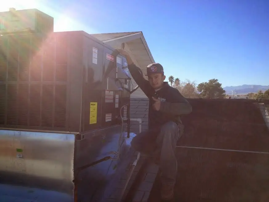 HVAC technician performing Air Duct Cleaning on a rooftop unit in Mount Healthy